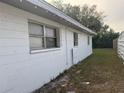 White side exterior wall with small yard at 4106 W Mango Ave, Tampa, FL 33616