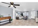 Bright living room with tile floors, comfy couch, and a ceiling fan at 7014 Ivanhoe Dr, Port Richey, FL 34668