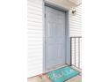 Gray front door with teal welcome mat at 7124 Waterside Dr # 7124, Tampa, FL 33617
