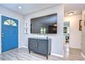 Bright entryway with blue door and large TV at 8504 Woodall Ct, Tampa, FL 33615