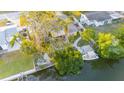 Wide aerial view of the home featuring a boat dock, lush landscaping, and backyard patio at 9665 2Nd N St, St Petersburg, FL 33702