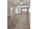 Spacious living room featuring light grey vinyl flooring and ceiling fan at 10459 Fly Fishing St, Riverview, FL 33569