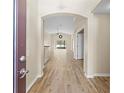 Light and airy foyer with tile floors and archway at 12922 Saulston Pl, Hudson, FL 34669