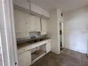 Small kitchen with white cabinets and double sink at 1311 11Th S Ave, St Petersburg, FL 33705