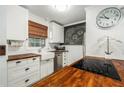 Modern white kitchen with butcher block countertops and farmhouse sink at 13716 Orange Sunset Dr, Tampa, FL 33618