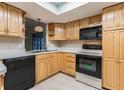 Well-lit kitchen, light wood cabinets, and black appliances at 13851 102Nd Ave, Largo, FL 33774