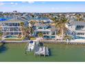 Waterfront property with a private dock, pool, and lush landscaping at 17077 Dolphin Dr, North Redington Beach, FL 33708