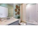 Bathroom with bathtub, vanity, and decorative wall accents at 17921 Tavernside Trl, Lakewood Ranch, FL 34211