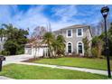 Two-story house with a three-car garage and manicured lawn at 18809 Chaville Rd, Lutz, FL 33558