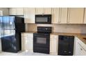 Well-equipped kitchen with black appliances and granite countertops at 19029 Us Highway 19 N # 23C, Clearwater, FL 33764