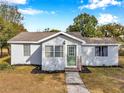 Quaint one-story house with a green door and well-maintained lawn at 2606 S Wilder Loop, Plant City, FL 33565