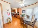 Eat-in kitchen with wood cabinets and flooring at 3020 Moss Hill St, Wesley Chapel, FL 33543