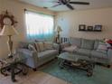 Inviting living room with tile floors, two couches, and a large window at 3060 64Th N Ave, St Petersburg, FL 33702