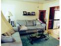 Comfortable living room featuring neutral couches, decorative pillows, and a glass coffee table at 3060 64Th N Ave, St Petersburg, FL 33702