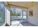 Bright screened porch with tiled floor and view of backyard at 30817 Prout Ct, Wesley Chapel, FL 33543