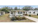 Landscaped mobile home with a carport at 36810 Kay Ave, Zephyrhills, FL 33542