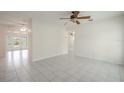 Bright living room with tile floors and ceiling fan at 404 Manor Blvd, Palm Harbor, FL 34683