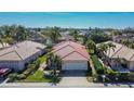 Single-story home with tile roof and two-car garage in a residential neighborhood at 4415 Muirfield, Bradenton, FL 34210