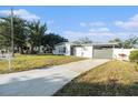 Newly renovated home with gray accents and a landscaped yard at 4918 Cresthill Dr, Tampa, FL 33615