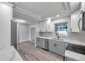 Modern kitchen with gray cabinets, white countertops, and stainless steel appliances at 5425 36Th N Ave, St Petersburg, FL 33710