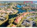 Aerial view of condo community by lake with resort-style amenities at 6816 Dali Ave # E206, Land O Lakes, FL 34637