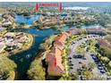 Aerial view showcasing condo community by lake with resort-style amenities at 6816 Dali Ave # E206, Land O Lakes, FL 34637