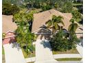 Community of tan houses with palm trees and a pond at 7402 Hamilton Rd, Bradenton, FL 34209