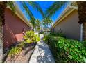 Landscaped walkway between two houses, leading to a gate at 7402 Hamilton Rd, Bradenton, FL 34209