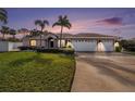 House exterior at dusk showcasing landscaping and garage at 9203 Sea Oaks Ct, Seminole, FL 33776