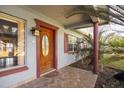 Inviting front door entrance with a brick walkway, a charming entryway at 10106 Tarpon Springs Rd, Odessa, FL 33556