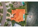 Aerial view of a waterfront property featuring a large house with a pool and private dock at 1097 Eden Isle Ne Dr, St Petersburg, FL 33704