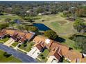 Community overview featuring villas, golf course, and pond at 1162 Rustlewood Ct, Palm Harbor, FL 34684