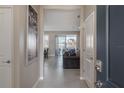 Bright and airy entryway offering a view of the living room at 13305 Waterleaf Garden Cir, Riverview, FL 33579