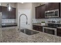 Modern kitchen with stainless steel appliances and granite countertops at 13305 Waterleaf Garden Cir, Riverview, FL 33579