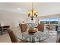 Bright dining area with glass table and waterfront view at 19725 Gulf Blvd # 405, Indian Shores, FL 33785