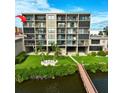 Condo building waterfront view, featuring a boardwalk at 19725 Gulf Blvd # 405, Indian Shores, FL 33785