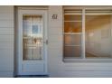 Condo building's front door with a window next to it at 2363 Israeli Dr # 61, Clearwater, FL 33763