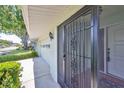 Front entry with a black security door and terracotta tile flooring at 2421 Lancaster Dr, Sun City Center, FL 33573