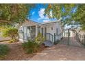 Charming home featuring a cozy screened-in porch, garden gate, and brick driveway at 2907 Clinton S St, Gulfport, FL 33707