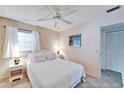 Bright bedroom with soft carpeting, a ceiling fan, and a comfortable bed with white bedding at 360 N Bayshore Blvd # 207, Clearwater, FL 33759