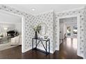 Bright entryway with stylish console table and floral wallpaper at 4811 Culbreath Isles Rd, Tampa, FL 33629