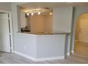 Open living room with light-grey walls, modern track lighting, and a view of the kitchen at 501 Knights Run Ave # 1113, Tampa, FL 33602