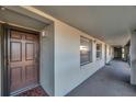 Condo hallway with brown door to unit 224 at 5197 Silent Loop # 224, New Port Richey, FL 34652