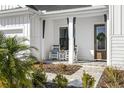 Inviting front porch with rocking chairs, and brick walkway at 6210 Nikki Ln, Odessa, FL 33556