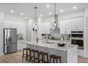 Modern kitchen featuring white cabinets, granite island, and stainless steel appliances at 6210 Nikki Ln, Odessa, FL 33556