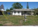 Small white single story home needing landscaping and exterior updates at 6701 Hibiscus S Ave, South Pasadena, FL 33707