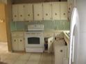 View of kitchen with white cabinets and appliances at 6720 Hibiscus S Ave, South Pasadena, FL 33707