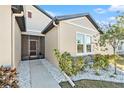 Front entrance with screened porch and nicely landscaped walkway at 732 Ocean Spray Dr, Ruskin, FL 33570