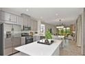 Spacious kitchen with island, stainless steel appliances, and white cabinets at 761 Steel Dr, Apollo Beach, FL 33572