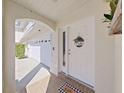 Inviting entryway with a white door and welcoming mat at 8229 Eagles Park N Dr, St Petersburg, FL 33709